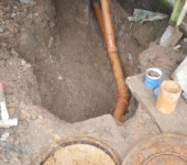 Dinasewer Dug up ground with exposed pipes