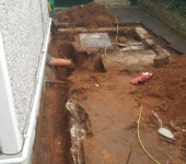 Dinasewer Dug up ground with exposed pipes